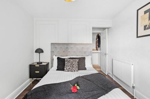 a bedroom with a large bed with a black and white blanket at Luxury Holiday Apartments in Torquay