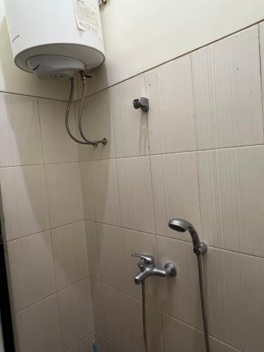 a shower in a bathroom with a shower head at Jojo's Villa Batu in Batu