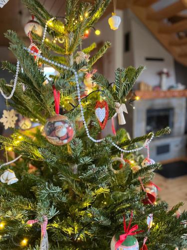 a christmas tree with christmas ornaments on it at Ciche Pole in Maniowy