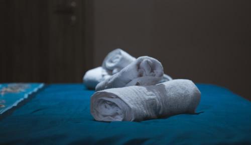 a pile of towels sitting on top of a bed at Villa Katerina in Polykárpion