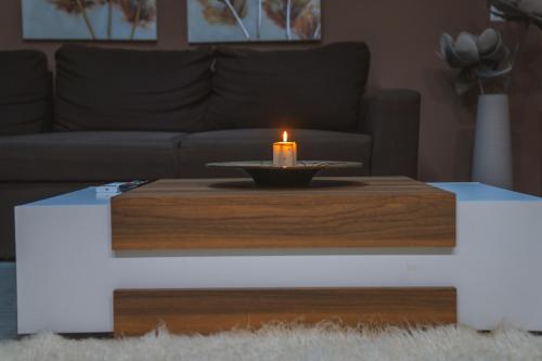 a candle on a coffee table in a living room at Villa Katerina in Polykárpion