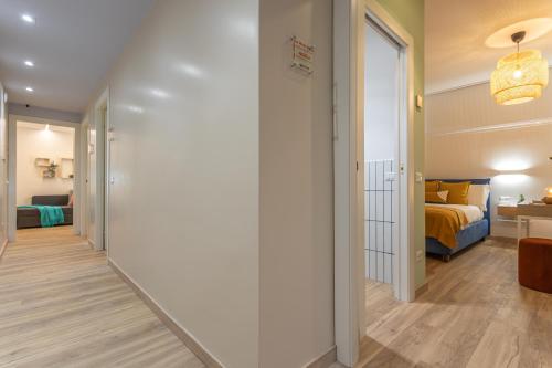 a hallway leading to a bedroom with a bed at Le Muse Suites in Rome
