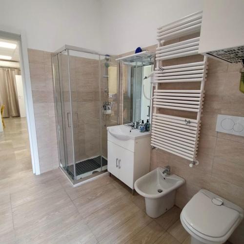 a bathroom with a shower and a toilet and a sink at B&b BorgoVenezia in Scorzè