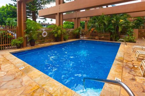 a swimming pool with a gazebo at Kaleialoha 409 · KA 409 OceanFront 1BD Condo w Ocean Views Pool in Kahana