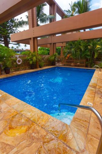a large swimming pool in a resort with a large at Kaleialoha 409 · KA 409 OceanFront 1BD Condo w Ocean Views Pool in Kahana