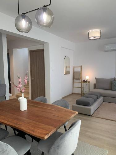 a living room with a wooden table and a couch at Villa 2 Golden View in Peyia