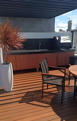 a kitchen with a table and a sink and a table at Get By Side in João Pessoa