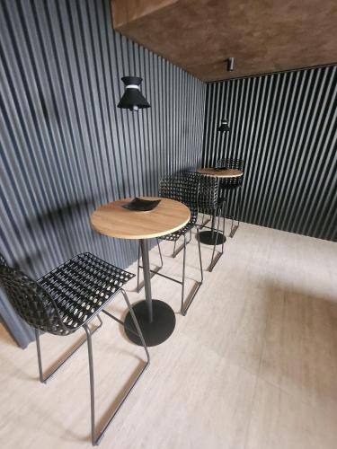 a group of tables and chairs in a room at Get By Side in João Pessoa