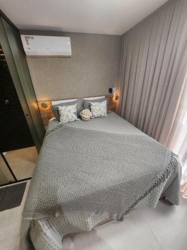 a bedroom with a large bed in a room at Get By Side in João Pessoa