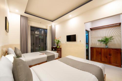 Sands River Hoi An Villaにあるベッド