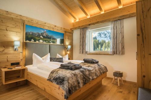 Posteľ alebo postele v izbe v ubytovaní sDahoam Luxury Chalet