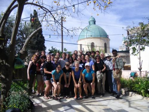a group of people posing for a picture in front of a building at Cana Wedding Guest House in Kafr Kannā