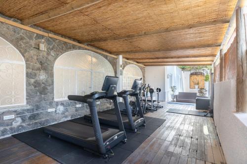 a gym with a row of exercise equipment in a room at Apollon Club & Thermal Spa in Ischia