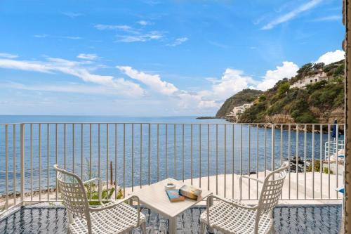 a balcony with a table and chairs and the ocean at Apollon Club & Thermal Spa in Ischia