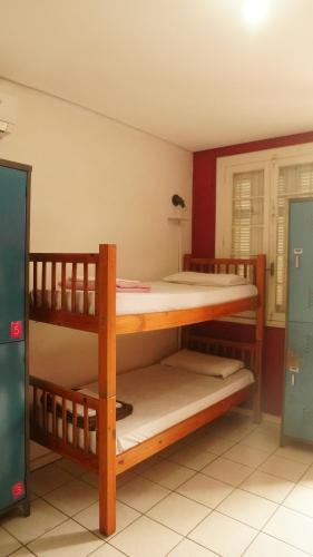a bedroom with two bunk beds in a room at POA Eco Hostel in Porto Alegre