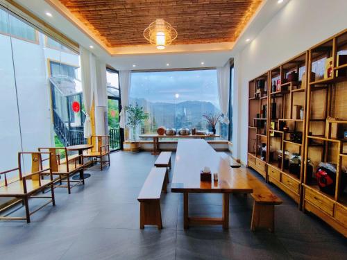 a large room with benches and a large window at Avatar Hilltop Manor B&B in Zhangjiajie