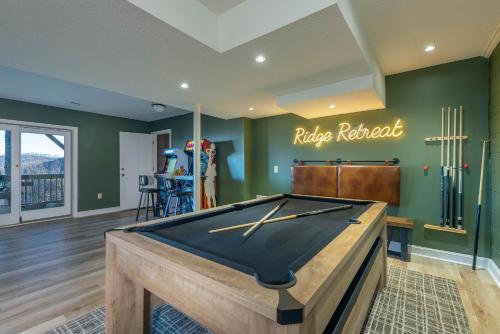 a pool table in a room with green walls at Mountain Views Hot Tub Family Room & Game Room in Swiss