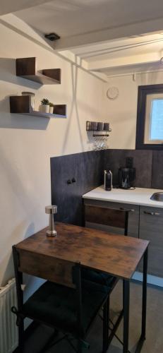 a kitchen with a wooden table in a room at Veluws Huisje in Apeldoorn