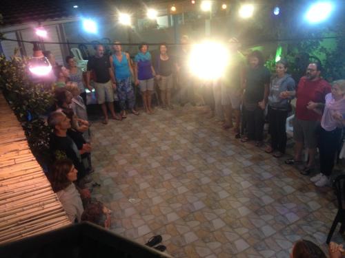 a group of people standing around a stage with a light at Cana Wedding Guest House in Kafr Kannā