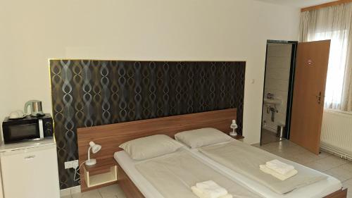 a bedroom with a large bed in a room at Pension Haus Nova in Wiener Neustadt