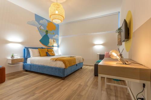 a bedroom with a bed and a desk in it at Le Muse Suites in Rome