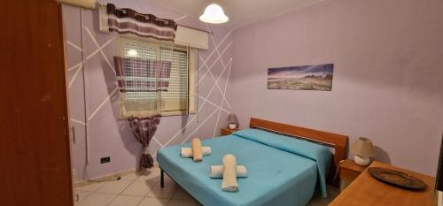 a bedroom with a blue bed with two crosses on it at Veranda Sul Beach Di Alcamo Marina in Alcamo Marina