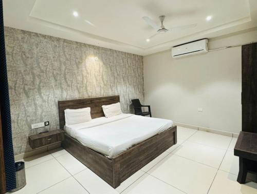 a bedroom with a bed and a desk in it at Hotel Pearl inn in Rudrapur