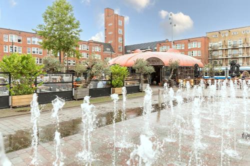 a fountain in the middle of a city with buildings at Gorgeous And Stylish Place For Two In Hip West! in Amsterdam