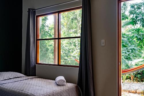 a bedroom with a bed and a large window at Taki Tambo Lodge in Tarapoto