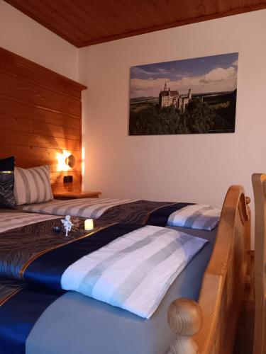 a bedroom with two beds and a painting on the wall at Sonne in Halblech