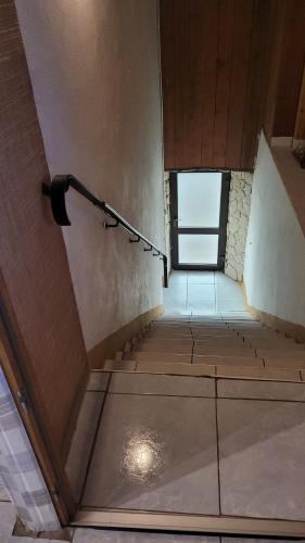 an empty room with stairs and a window at maison de vacances FRECONRUPT in La Broque