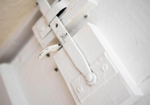 a white wooden door with a white handle at Stone Hall Mill Cottage - Tranquil Countryside Haven in Pembrokeshire in Saint Lawrence
