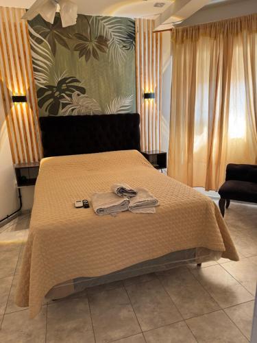 a bedroom with a bed with two towels on it at Valentino in Termas de Río Hondo
