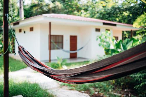 a hammock in front of a house at Taki Tambo Lodge in Tarapoto