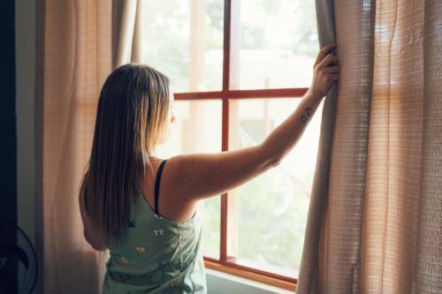 a woman is looking out of a window at Taki Tambo Lodge in Tarapoto