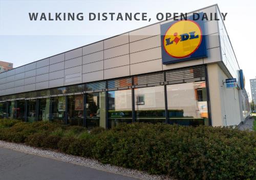 a building with a walking brilliance sign on it at VOUSATÁ DÁMA - PS3 - Parking free in Prague