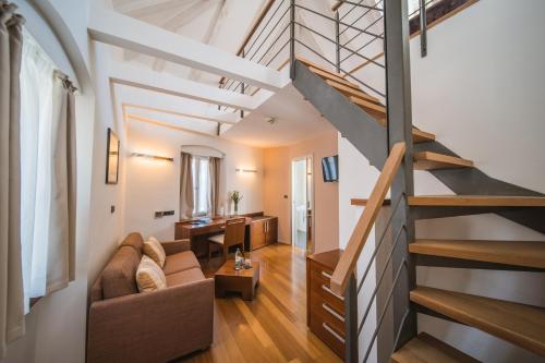 a living room with a staircase in a loft at Hotel Vestibul Palace & Villa - Small Luxury Hotels Of The World in Split