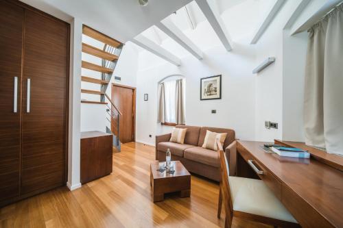 a living room with a couch and a table at Hotel Vestibul Palace & Villa - Small Luxury Hotels Of The World in Split
