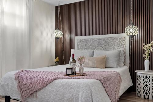 a bedroom with a bed with a bottle of wine at Luxury Zen Den with heated pool just off Siesta Key in Sarasota