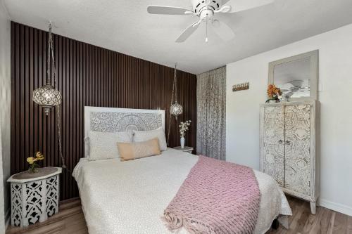 a bedroom with a bed and a ceiling fan at Luxury Zen Den with heated pool just off Siesta Key in Sarasota