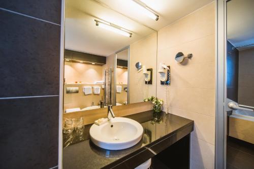 a bathroom with a sink and a mirror at Hotel Vestibul Palace & Villa - Small Luxury Hotels Of The World in Split