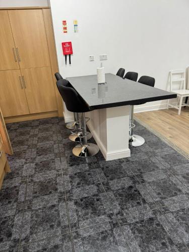 a conference room with a table and chairs at Sangha Hall in Leicester