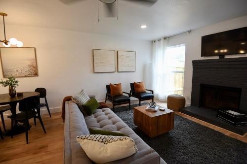 a living room with a couch and a fireplace at Stylish 2 suite condo minutes to food, music, fun in Austin