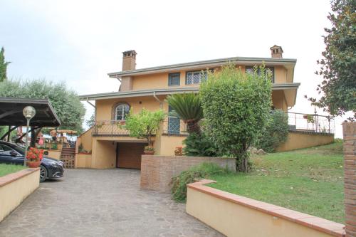 a house with a car parked in front of it at Boteroom Relais in La Volla