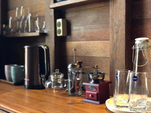 a counter top with several glass appliances on it at Lagoon Bungalows Bali in Nusa Dua