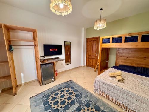 a bedroom with a bed and a tv in it at Ocean Life Dahab in Dahab