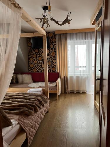 a bedroom with a bunk bed and a window at WIlla JODŁA JACUZZI&SAUNA in Poronin