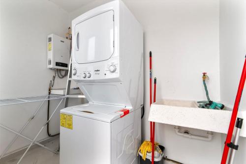 a small kitchen with a washing machine and a sink at Perfect resort style House in Playa del Carmen