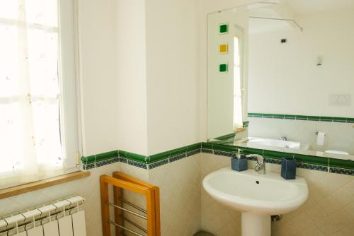 a bathroom with a sink and a mirror at Boteroom Relais in La Volla