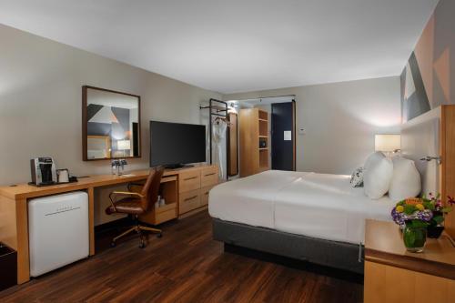 a hotel room with a bed and a desk at The Beeman Hotel in Dallas
